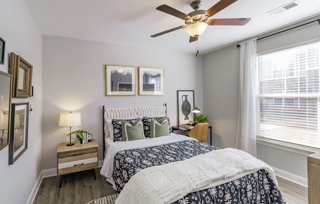 a bedroom with a bed and a ceiling fan
