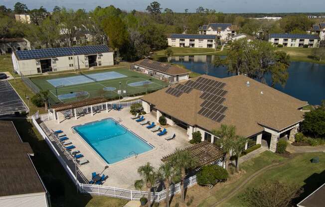 an aerial view of the pool and tennis court at the resort