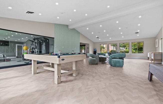 a large game room with a pool table and chairs at Edge At Farmington Hills - Farmington Hills, MI, Michigan