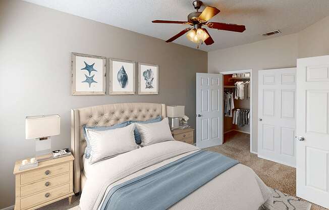 a bedroom with a bed and a ceiling fan