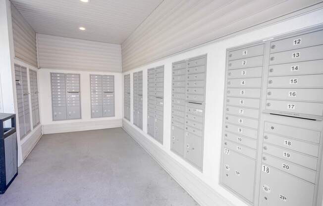 A room with a white ceiling and walls, containing a number of drawers with numbers on them.