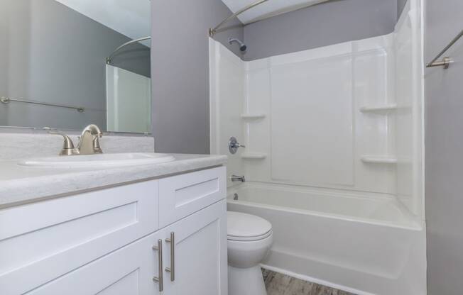 a bathroom with a sink toilet and a shower