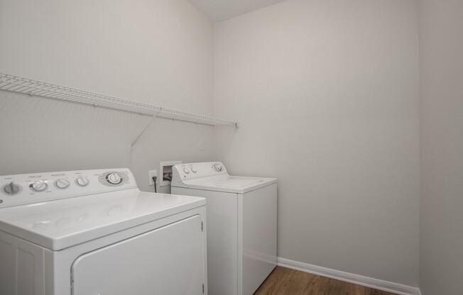 an empty laundry room with white appliances and a washer and dryer at Sladestone Shadow Creek, Pearland, TX, 77584