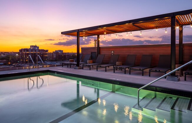 Pool on rooftop with lounge seating under pergola