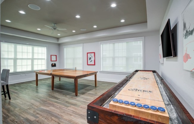 a games room with a shuffleboard table and a foosball table