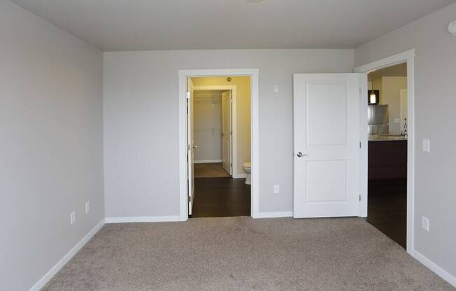 A room with a carpeted floor and white walls.