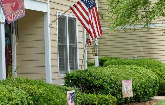 a house with two flags in the front yard