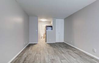 a bedroom with gray walls and a wooden floor