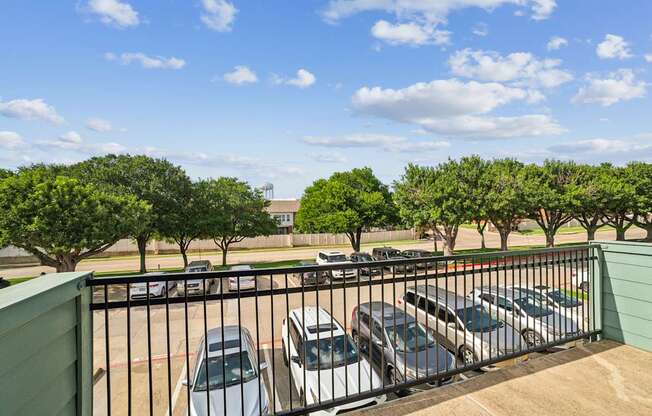 A parking lot with cars and trees.