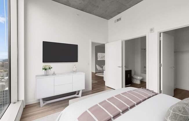 A modern bedroom with a large bed and a television.