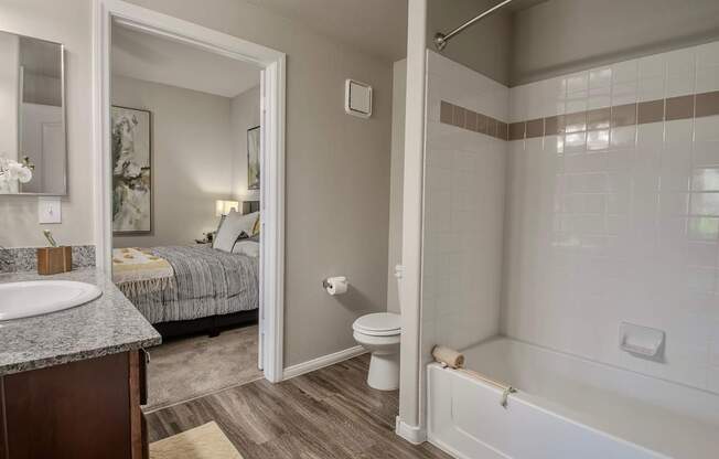 A bathroom with a toilet, sink, and bathtub.