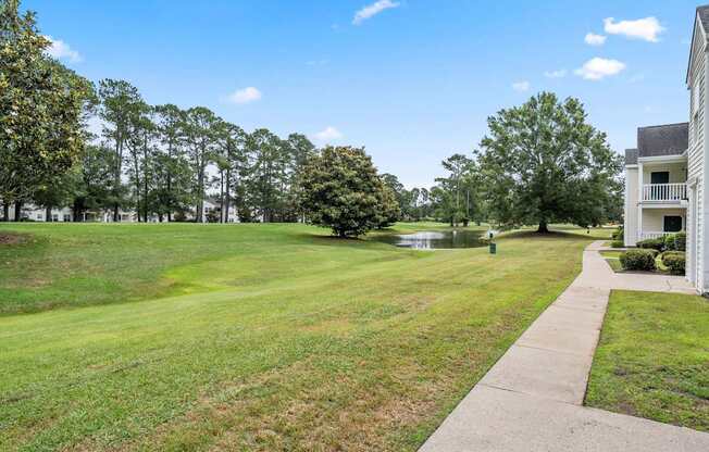 A grassy field with a building on the right side.