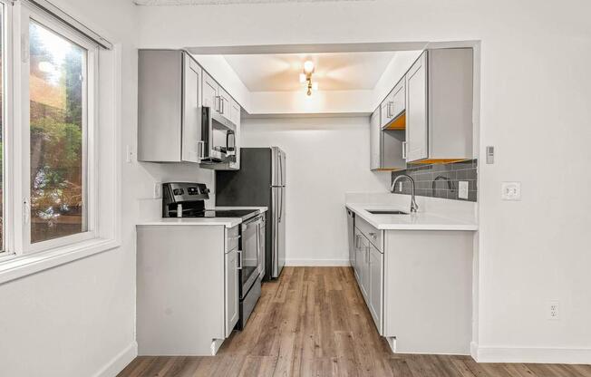 a kitchen with a stove top oven next to a window