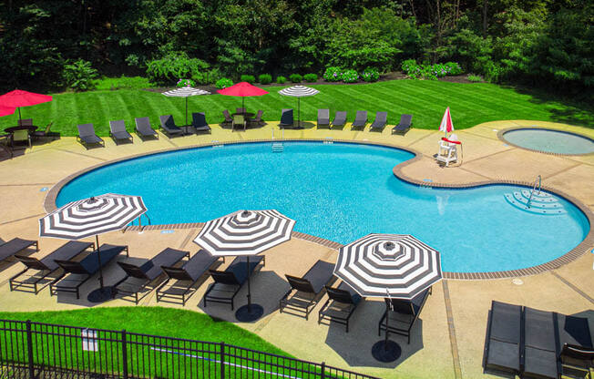 a swimming pool with umbrellas and chairs around it
