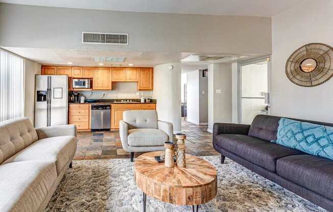A modern living room with a grey couch and a wooden coffee table.