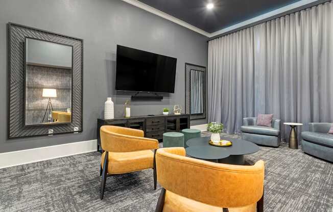 a living room with a tv and a table and chairs at Madison on the Meadow, Stafford, TX, 77477