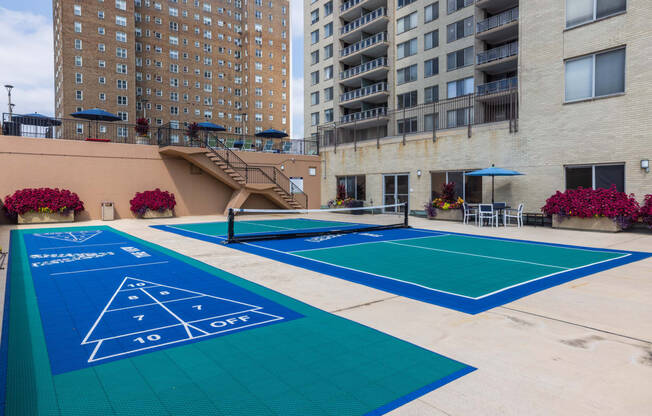 a view of the outdoor tennis court at the bradley braddock road station apartments