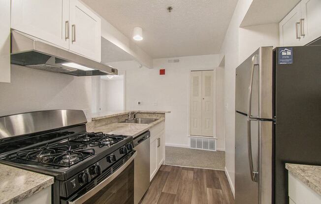 A kitchen with stainless steel appliances and white cabinets at Brentwood Park Apartments, La Vista, Nebraska