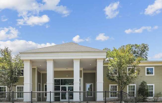 A row of houses with a black fence in front.