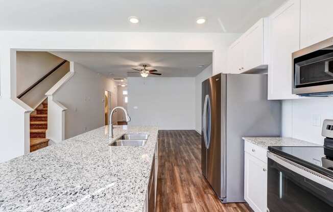 a kitchen with granite counter tops and stainless steel appliances