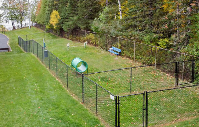 fenced in dog park at Les Chateaux apartments