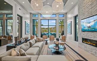 a living room with couches and a view of the ocean  at Altis Grand Suncoast, Land O' Lakes, 34638
