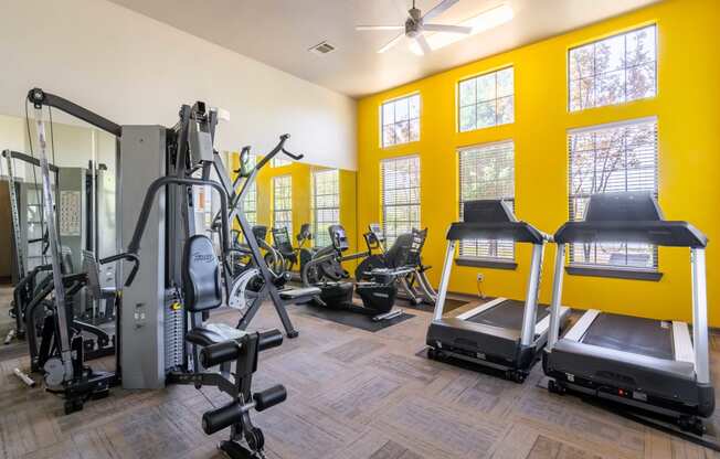 gym with cardio equipment at the whispering winds apartments in pearland, tx