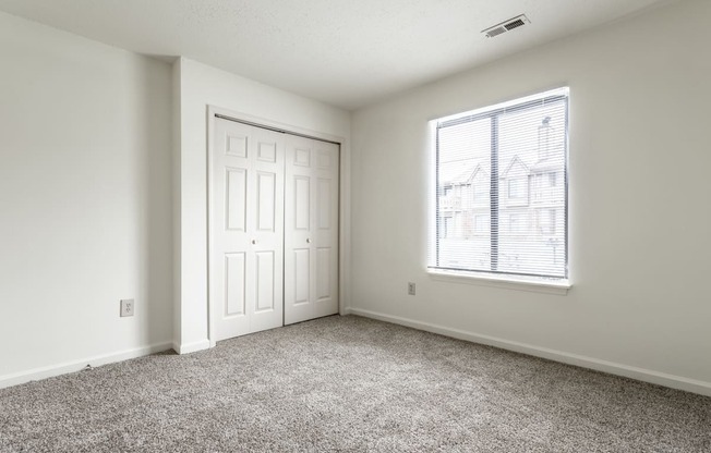 an empty room with a window and a door at Pheasant Run in Lafayette, IN 47909