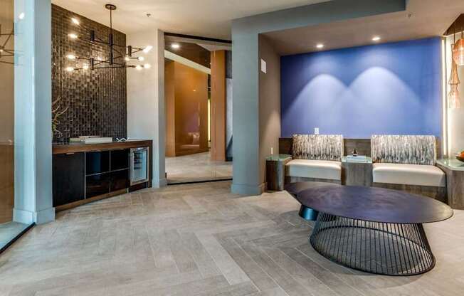 A modern living room with a black coffee table and a blue accent wall.