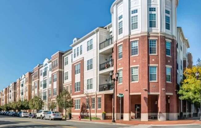 A red brick building with a white section on the top floor.