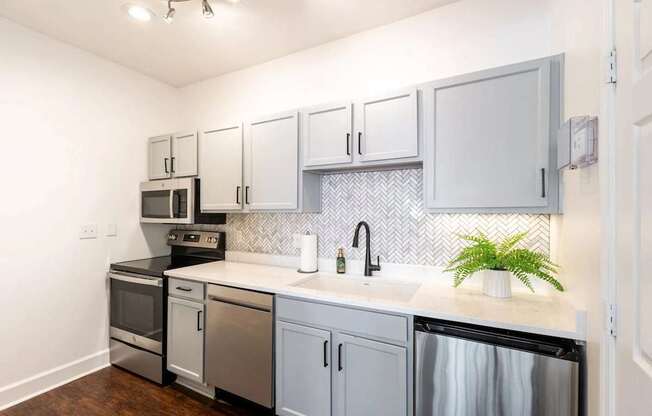 A kitchen with a black oven and a black dishwasher.at Crestline Cary, Cary North Carolina