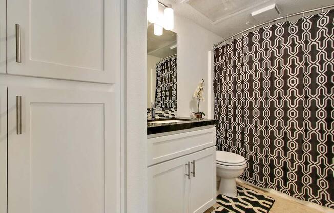 a bathroom with a black and white shower curtain  at Masselin Park West, California