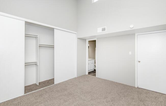 a bedroom with a building in the background