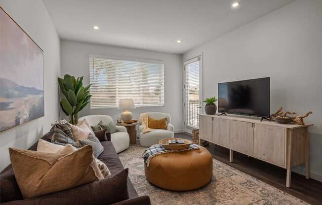 a living room with couches and a tvat Westbury Apartments, California