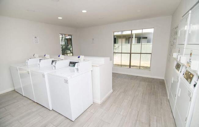 Clothing care center showing washing machines and dryers.