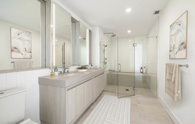 a bathroom with a large vanity and a glass shower