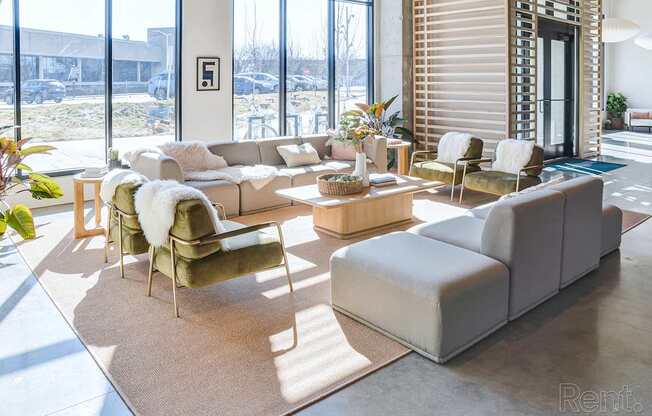 A living room with a couch, chair, and table.