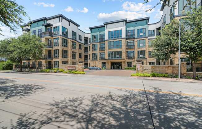 a large apartment building with a street in front of it