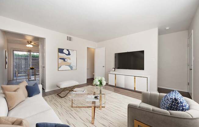A living room with a grey couch and a coffee table.