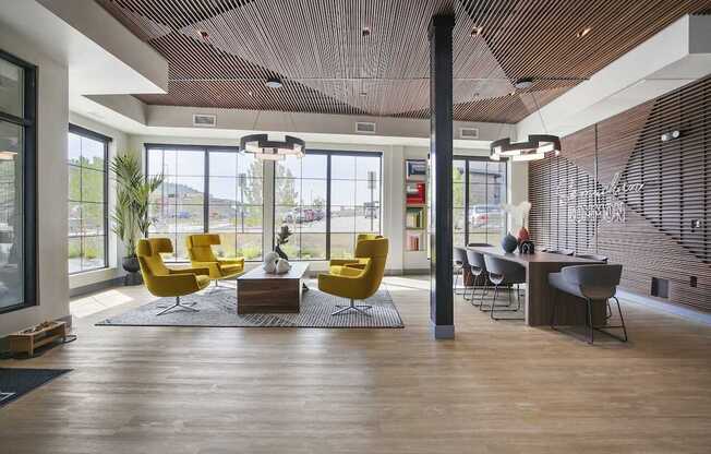 A modern office space with yellow chairs and a wooden floor.