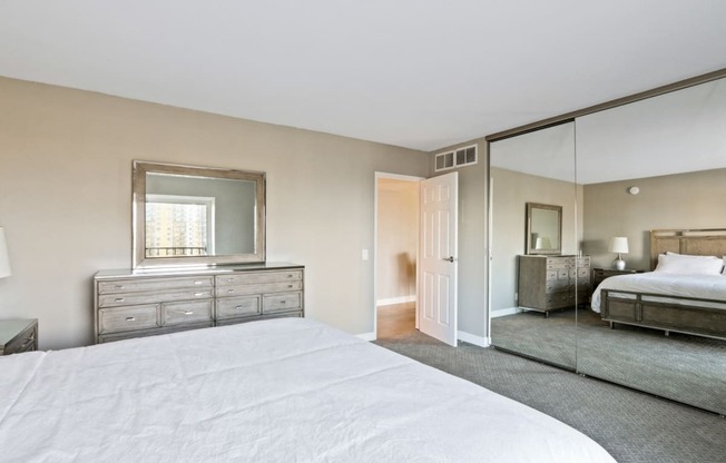 Bedroom with mirrored closet doors, carpet floorings