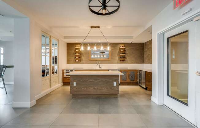 a large kitchen with a center island and a clock on the wall