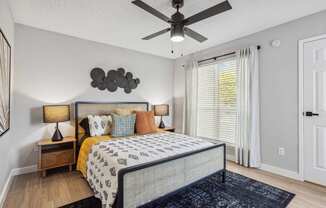 a bedroom with a bed and a ceiling fan