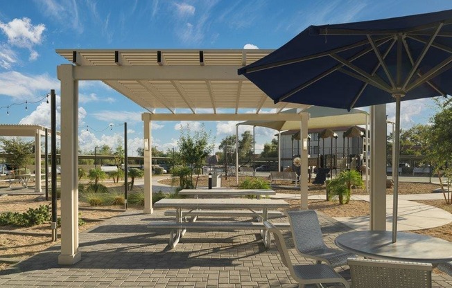 a picnic area with tables and umbrellas