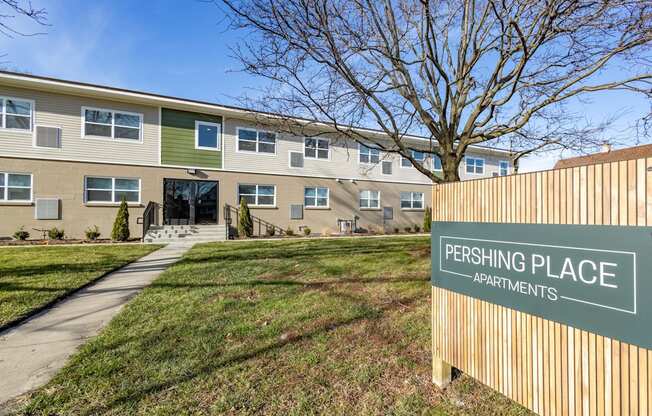 an apartment building with a parking place sign in front of it