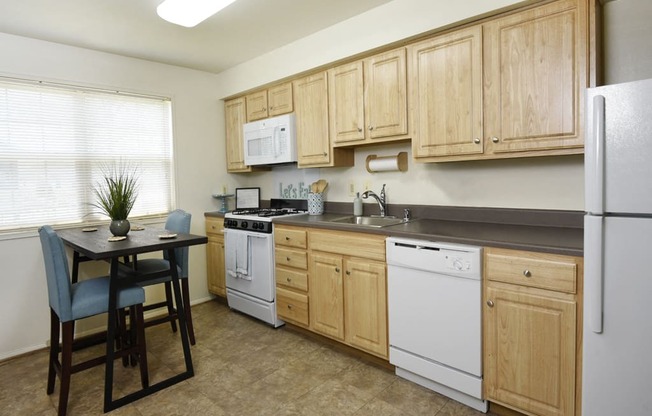 Bright eat in kitchen with extra storage at Kingston Townhomes, Baltimore, MD