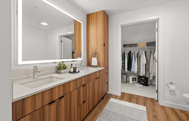 A bathroom with a sink, mirror, and wooden cabinets.