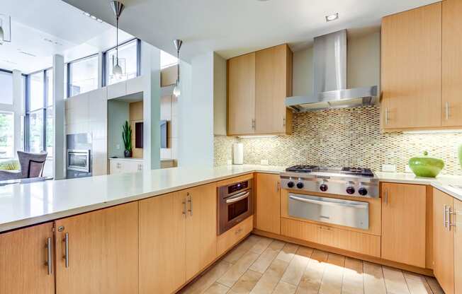 Mission Bay San Francisco Apartments-Venue Apartments Kitchen With Wooden Cabinetry And Multi-Colored Tile Backsplash