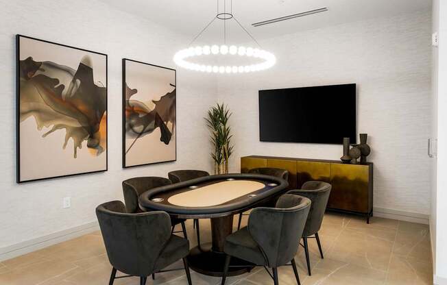 A modern dining room with a round table and chairs.