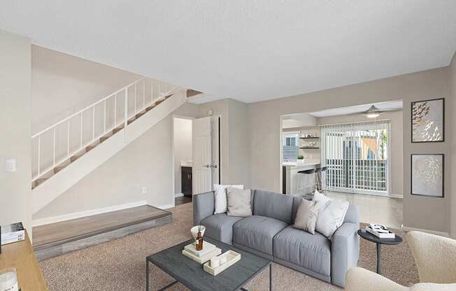 Model Living Room with Carpet and View of Kitchen at Horizon Apartments located in Santa Ana, CA.